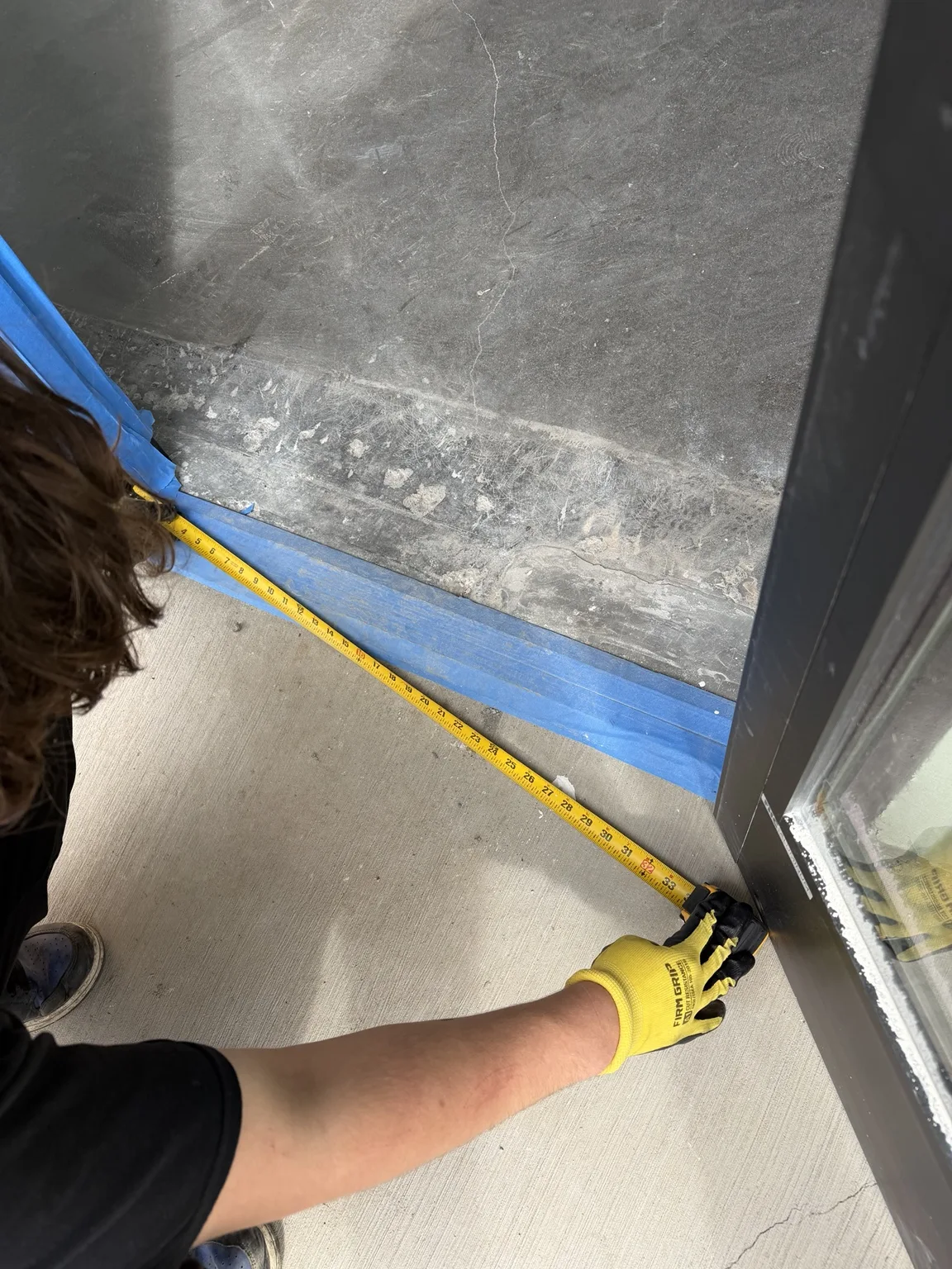 Crew member measuring a doorway opening during JunkPDX project planning