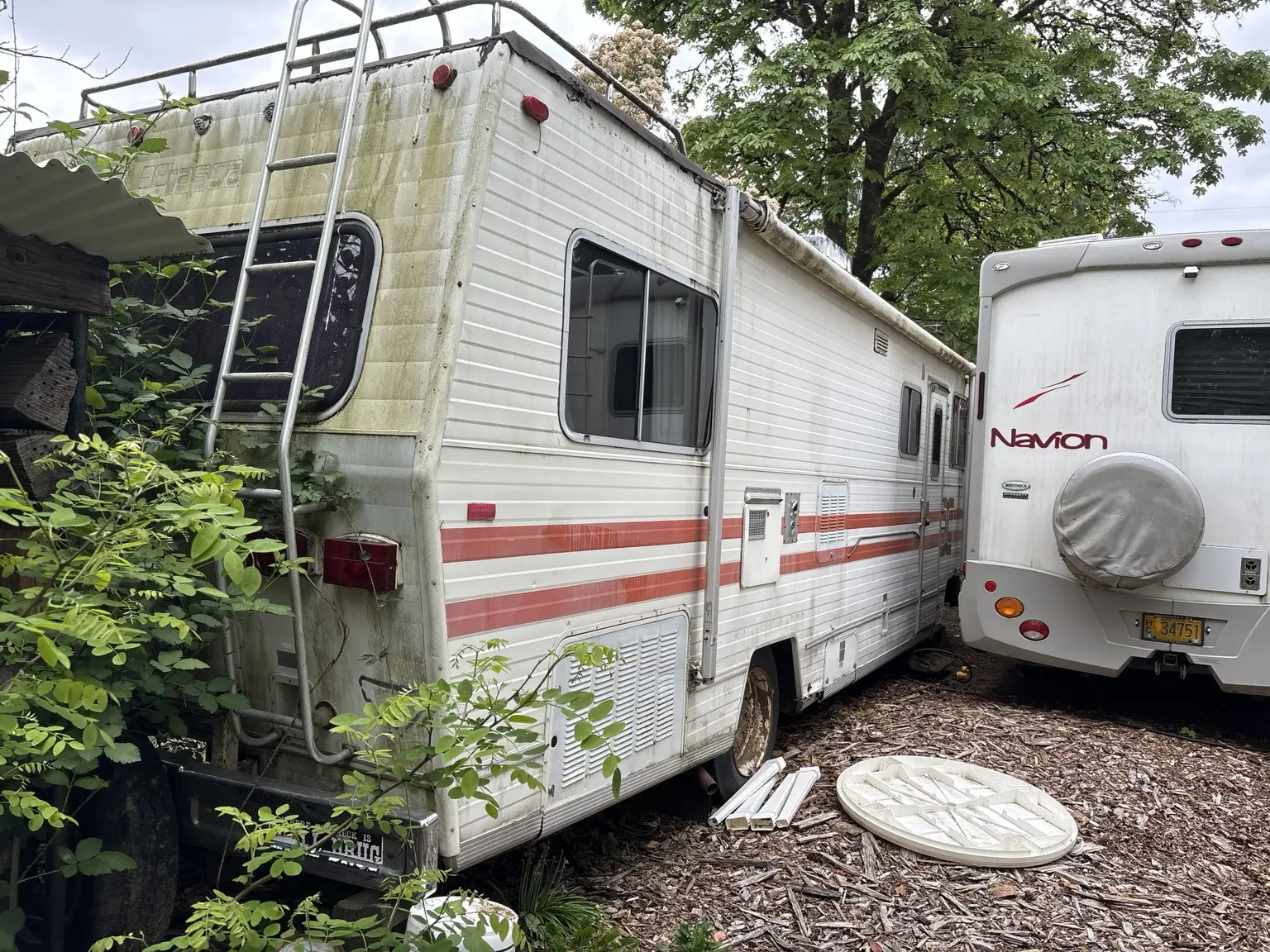 Side and rear access around an older RV reviewed for a Portland-area cleanup or removal plan