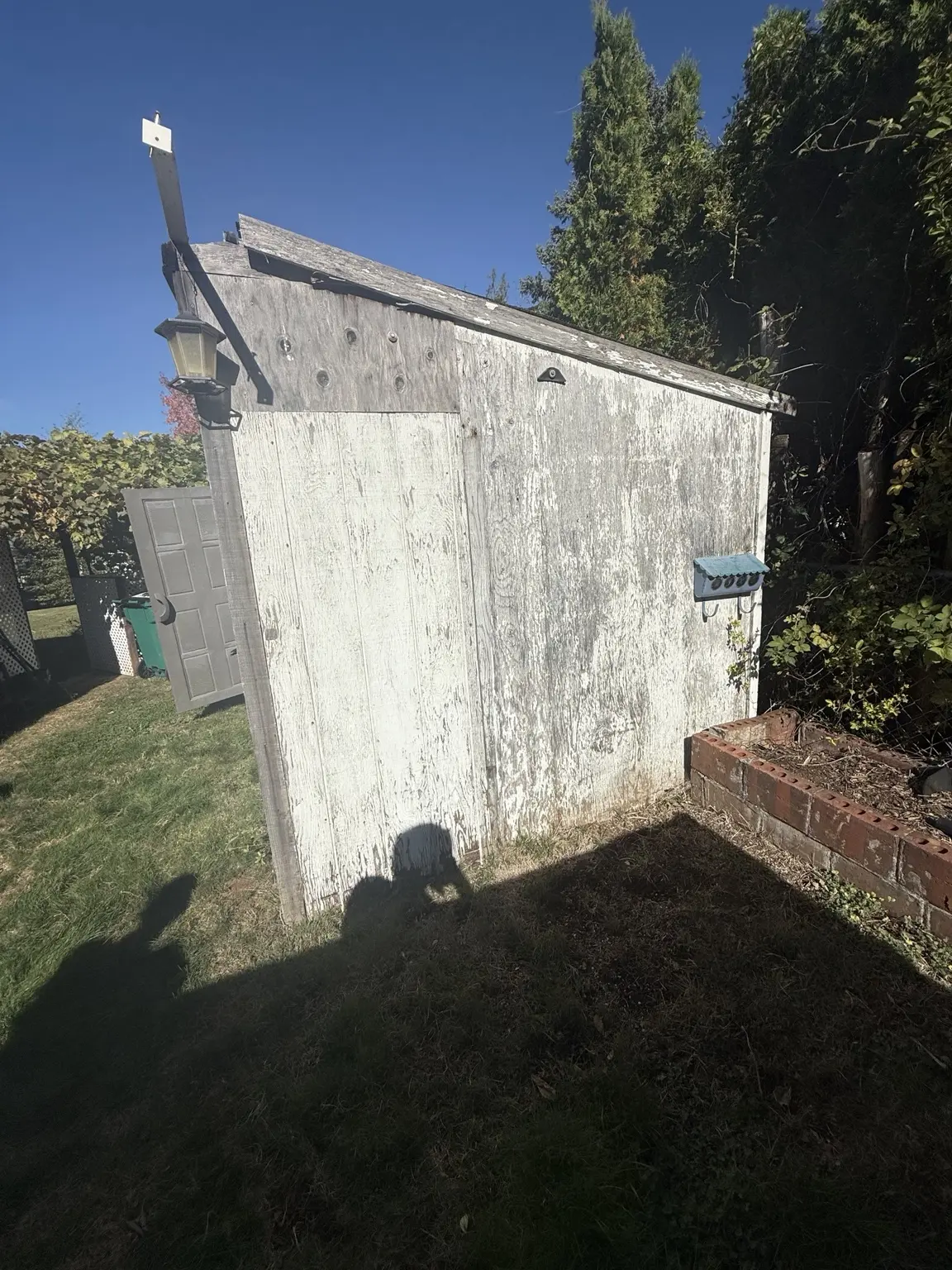 Weathered wooden backyard shed before JunkPDX cleanout and removal review