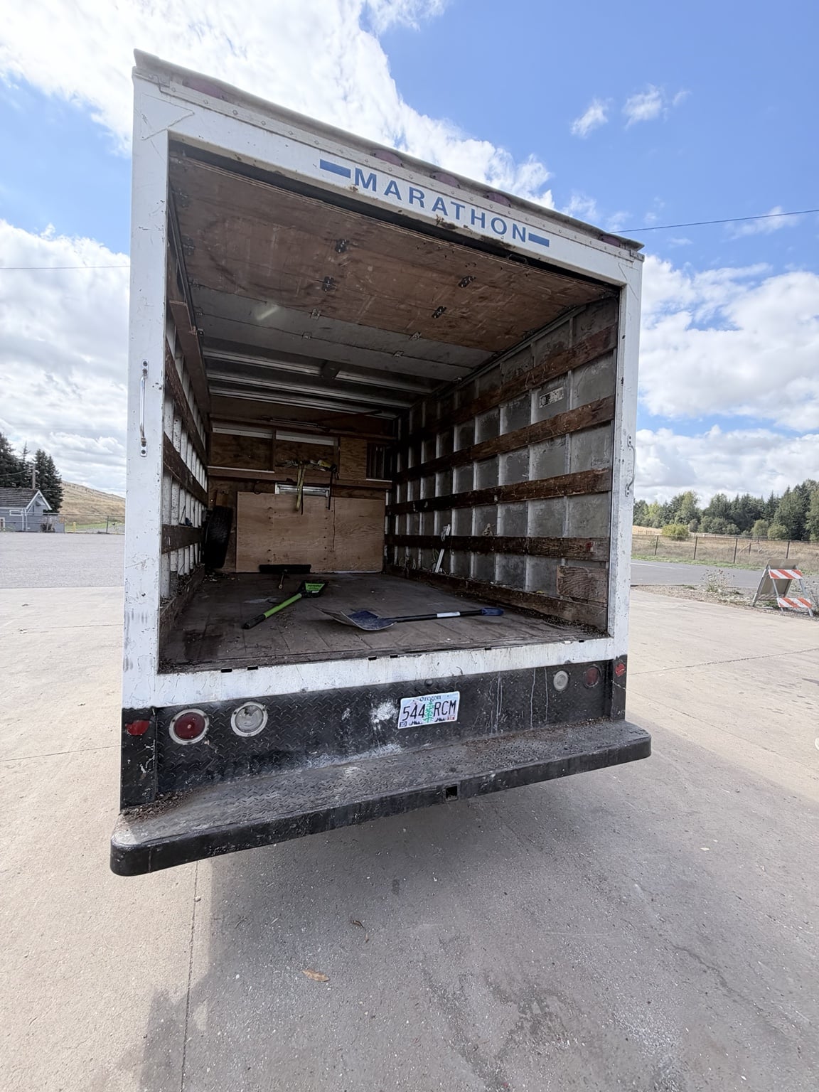 Rear view of JunkPDX’s box truck with the cargo door open